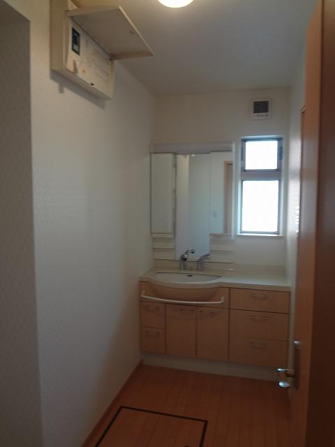 Wash basin, toilet. There is a window to wash room