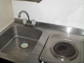 Kitchen. The kitchen is equipped with storage shelves in under the sink.