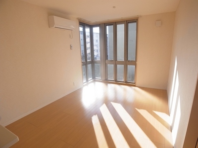 Living and room. The corner of the living-dining is turned to the window contains the light.