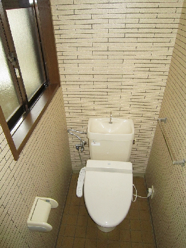 Toilet. It is a restroom with a clean feeling with a bidet. 