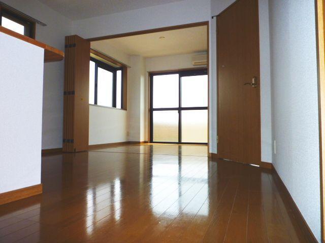 Living and room. Flooring is shiny