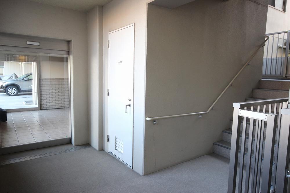 Other common areas. It is the exit-only automatic door to the parking lot side. Stairs also located in close.