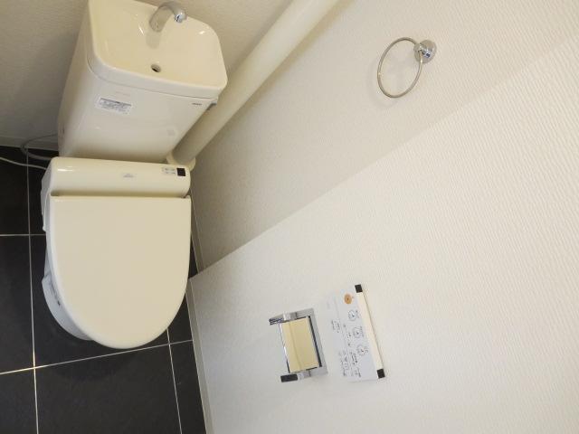 Toilet. Bidet with toilet. Floor is fashionable floor tile.