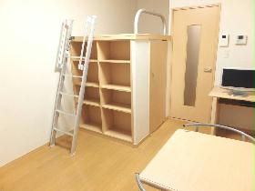 Living and room. Beds are and a flat-screen TV in the room with built