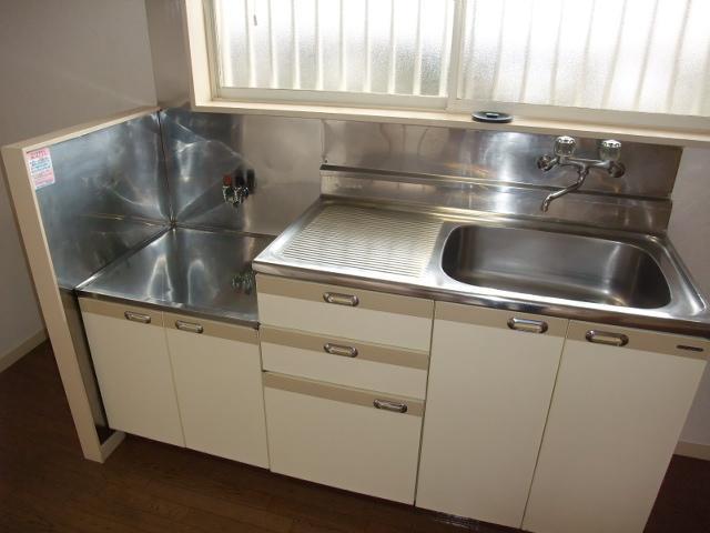 Kitchen. Two-burner stove possible. Spread of kitchen.