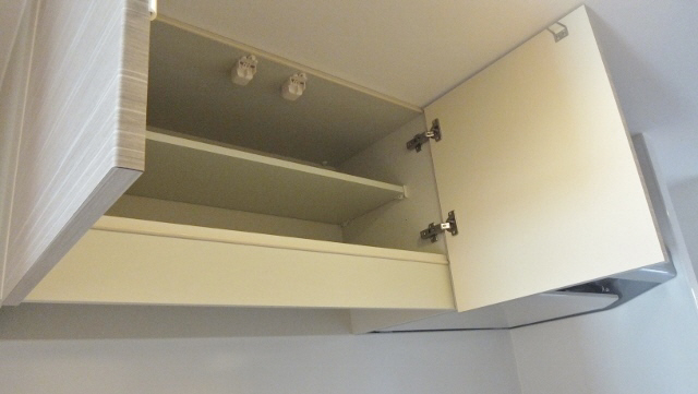 Kitchen. There are storage shelves in the kitchen top