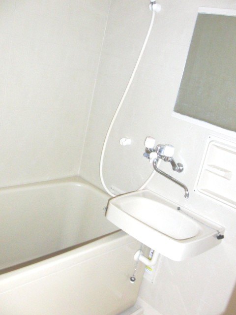 Bath. There is a mirror in the bathroom.