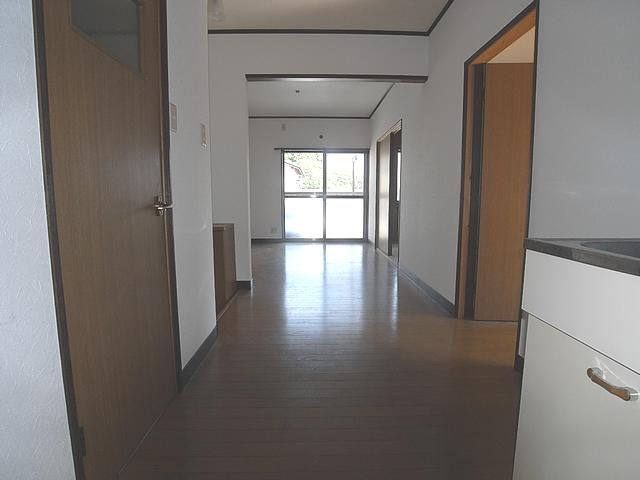 Living and room. It is a photograph from the kitchen. 