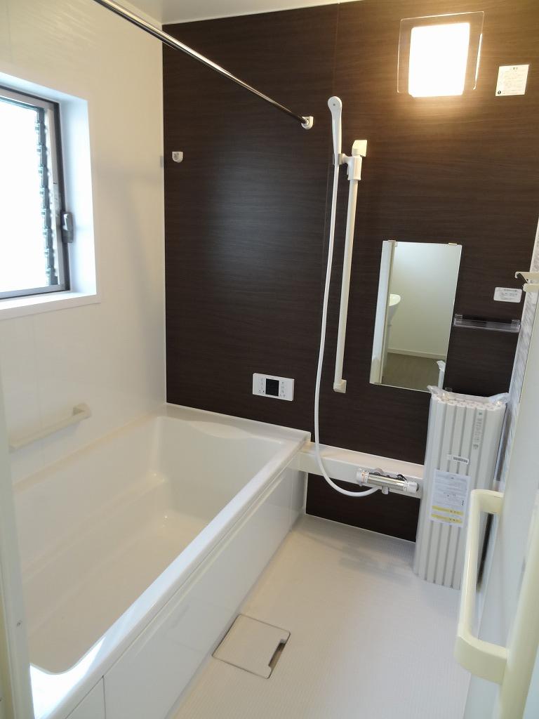 Bathroom. The bathroom also has a large window.