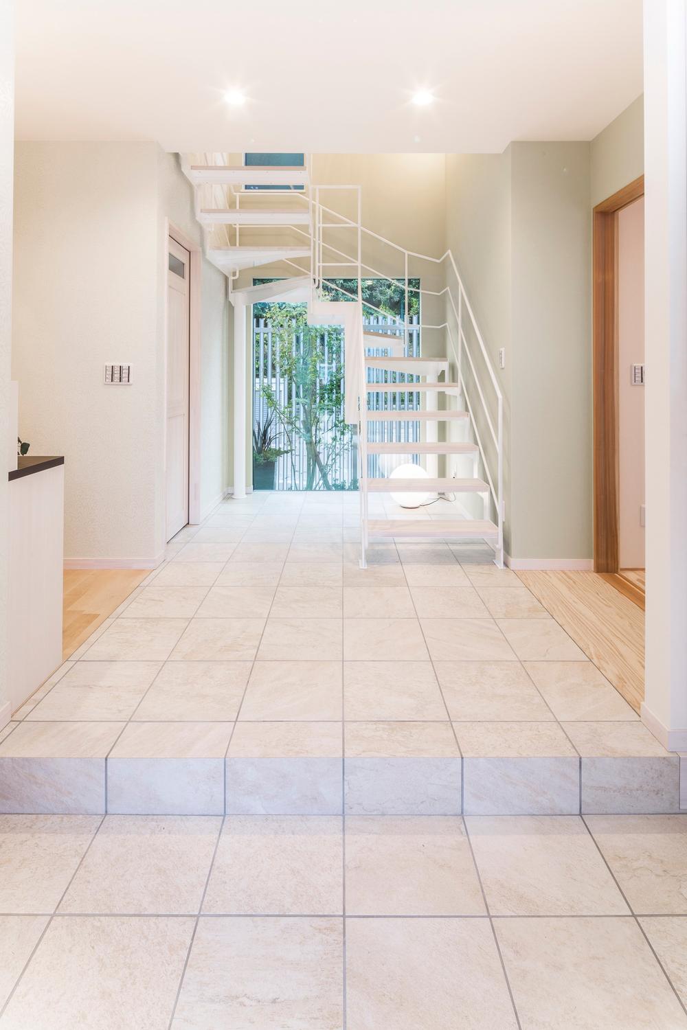 Building plan example (introspection photo). Entrance of the white tiled. Visible Tsuboniwa in the back, To luxury impression.