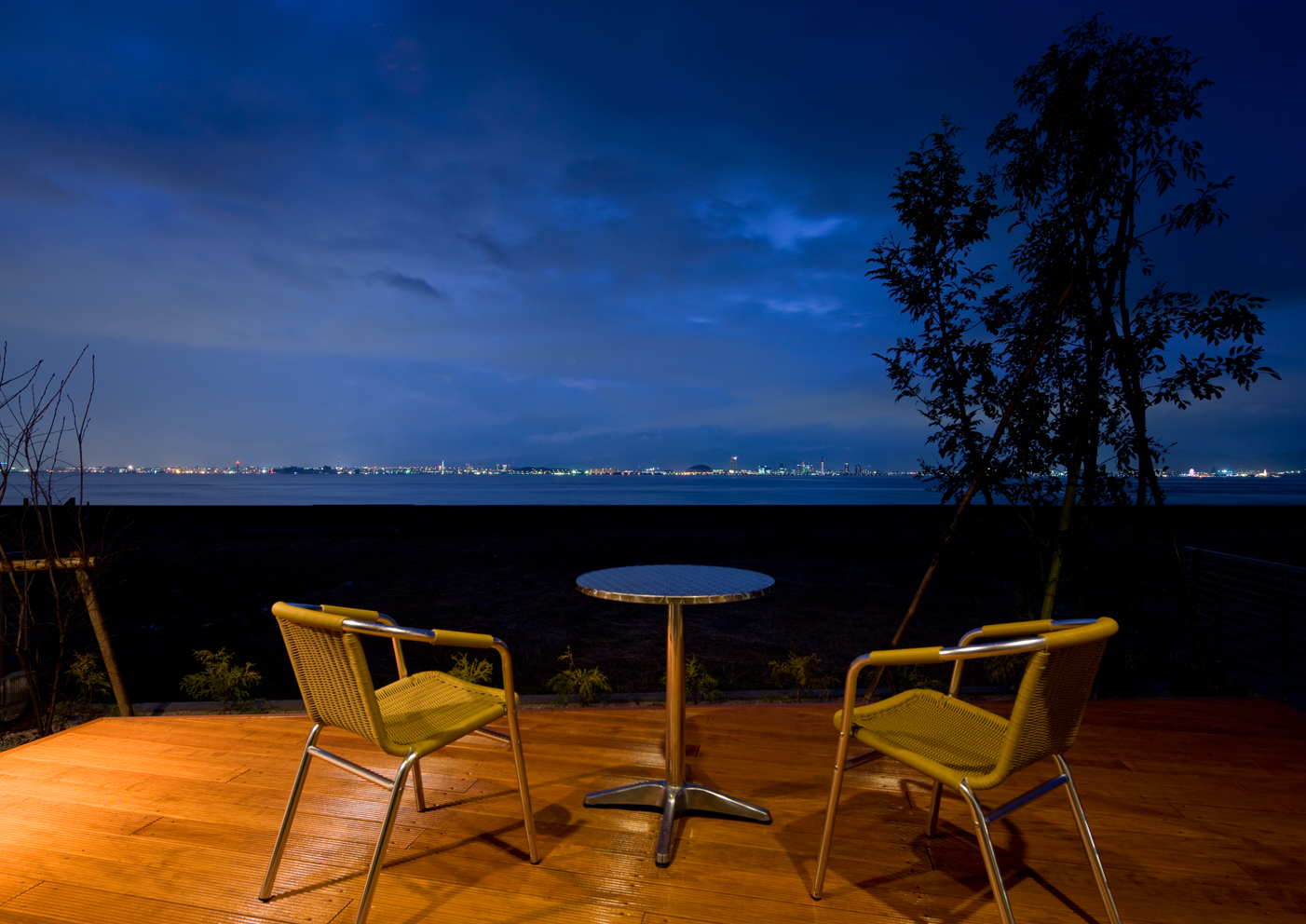 Model house photo. Place the chair on the wood deck at night, It is also possible to look relaxed and the night view (from the local model house)