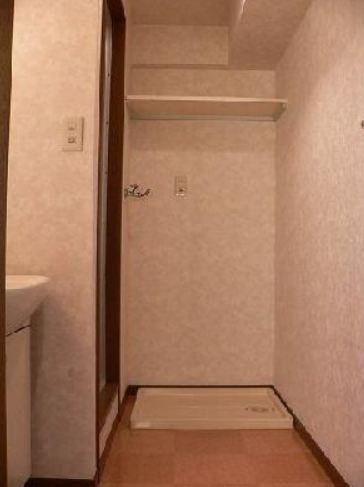 Washroom. Washing machine in the room