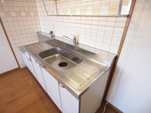 Kitchen. There is a refrigerator storage in the kitchen next to. 