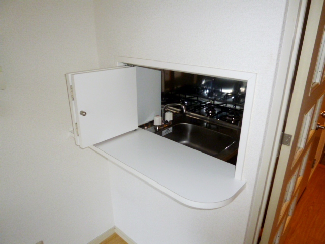 Living and room. You can see TV while cooking!