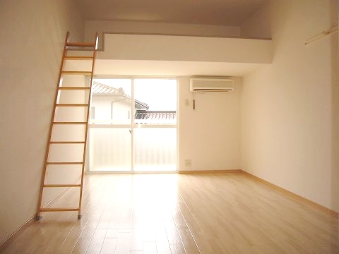 Living and room. It is a loft with a spread of the room.