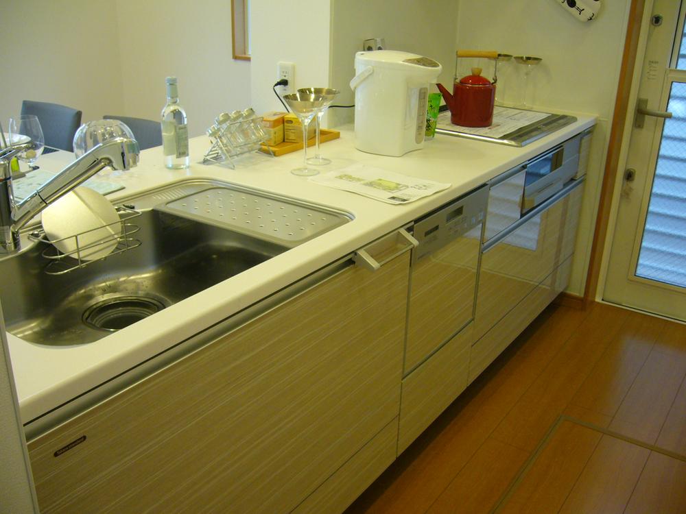 Kitchen. It is a functional kitchen with a dishwasher.