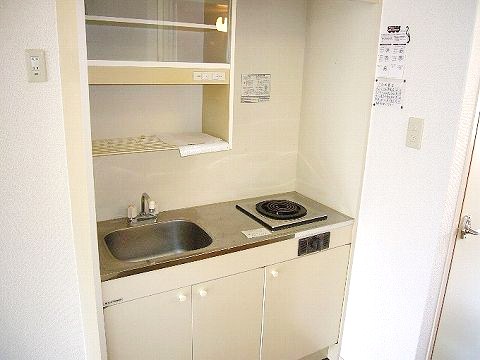 Living and room. It is a kitchen with a stove.