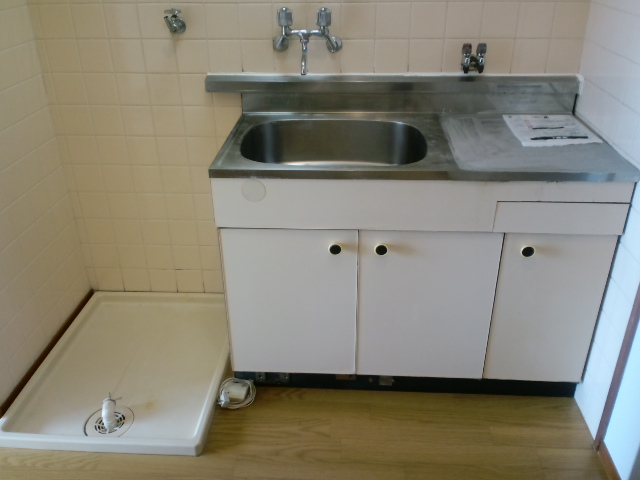 Kitchen. Mini-kitchen and washing machine Storage.