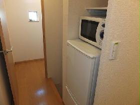 Living and room. refrigerator, It is with a microwave oven.