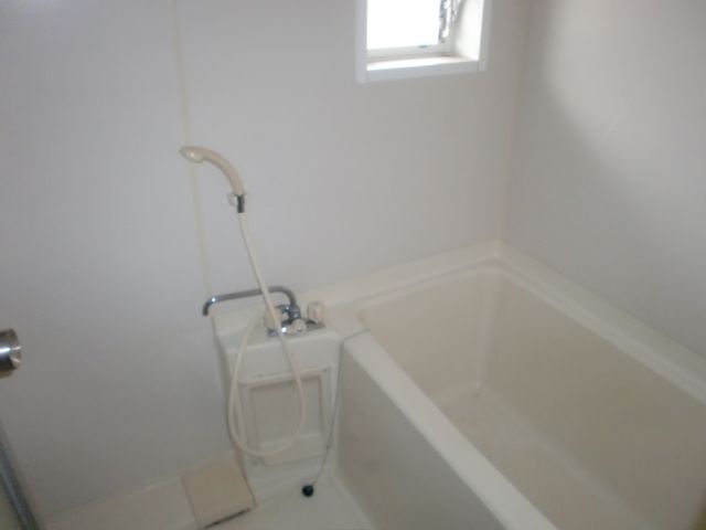 Bath. It is a bath with a small window. 