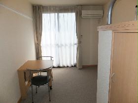 Living and room. It is a photograph that was taken from the room entrance