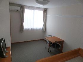 Living and room. It is a photograph taken from the top of the bed