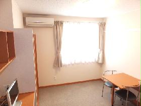 Living and room. It is a photograph that was taken from the bed top