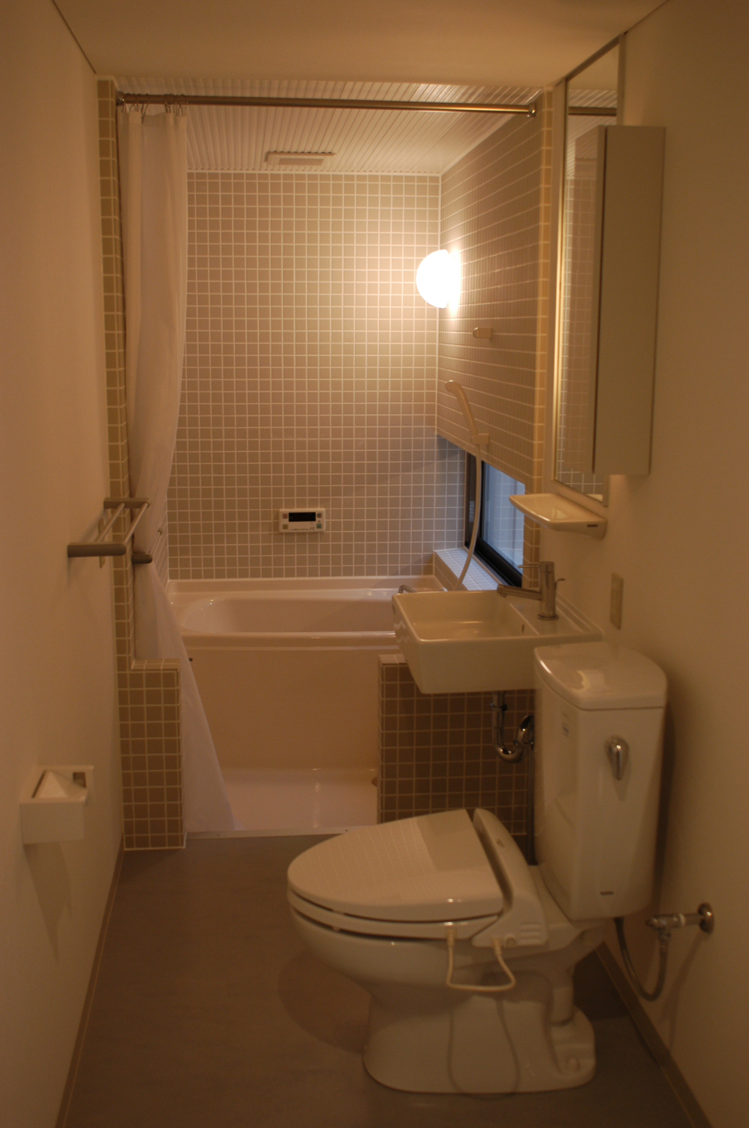 Bath. Washing machine storage and toilet together