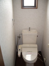 Toilet. There is a window in the toilet. 