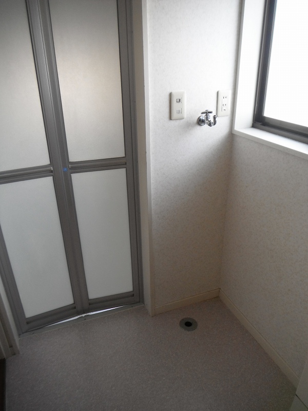 Washroom. Washing machine in the room