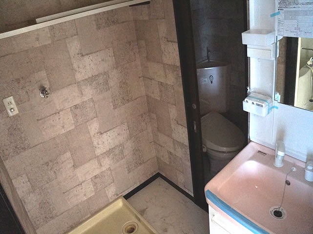 Washroom. With in-room washing machine storage