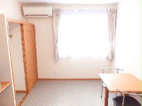 Living and room. It is a photograph that was taken from on the bed