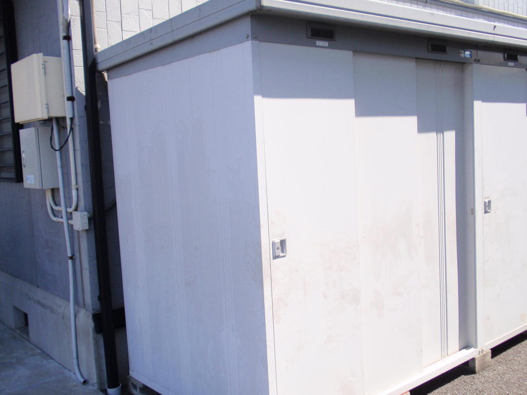 Other. Outside large storeroom (tire can be stored)