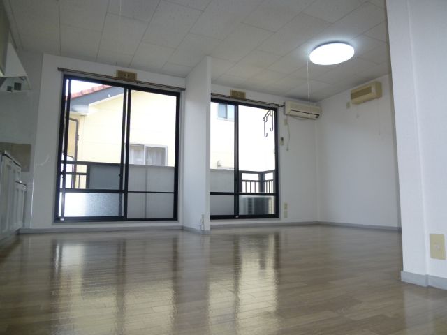 Living and room. There are two large windows, Bright is.