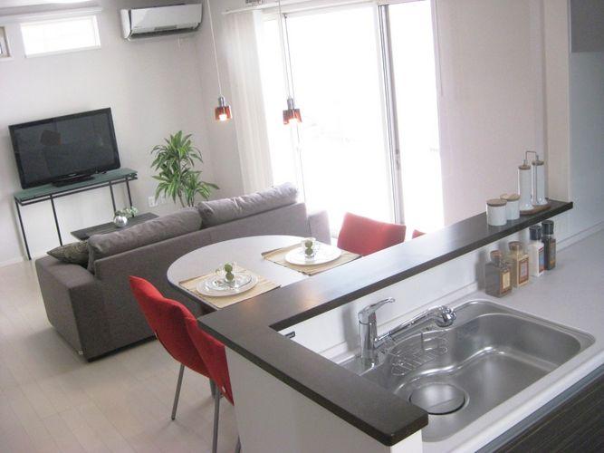 Kitchen. It is face-to-face kitchen finished in stylish dark brown to bright colors of flooring. Cup board also has total coordination.