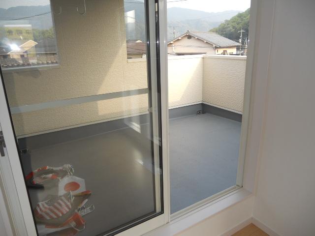 Balcony. It is a big balcony, Also it comes with a roof because it is safe even in the rain. 