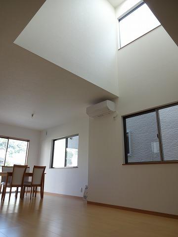 Living. There is a vaulted ceiling, Living room bathed in bright light