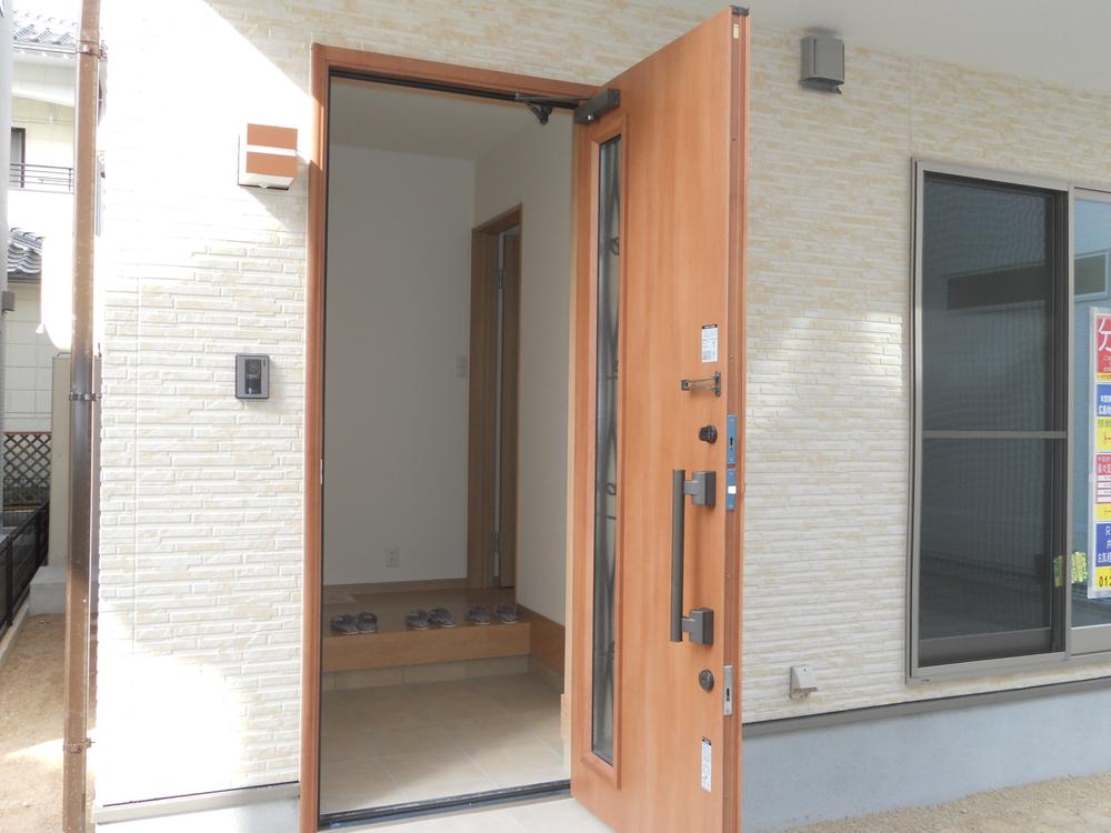 Entrance. A large shoe box you open the entrance door. 