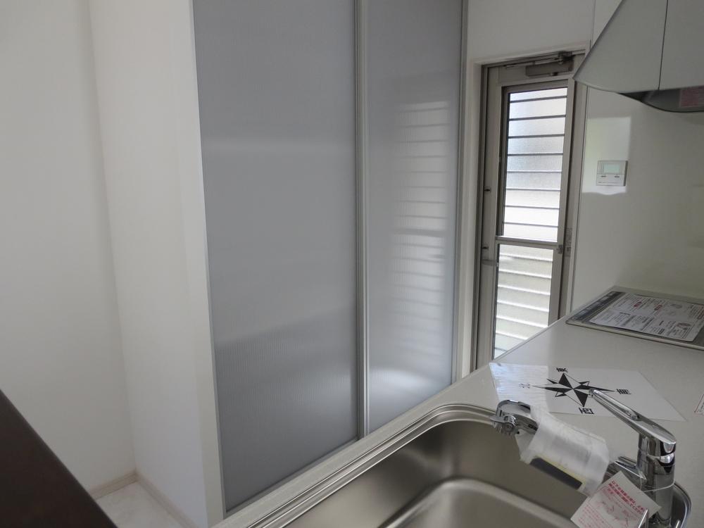 Other. Cupboard with a sliding door in the back of the kitchen. 