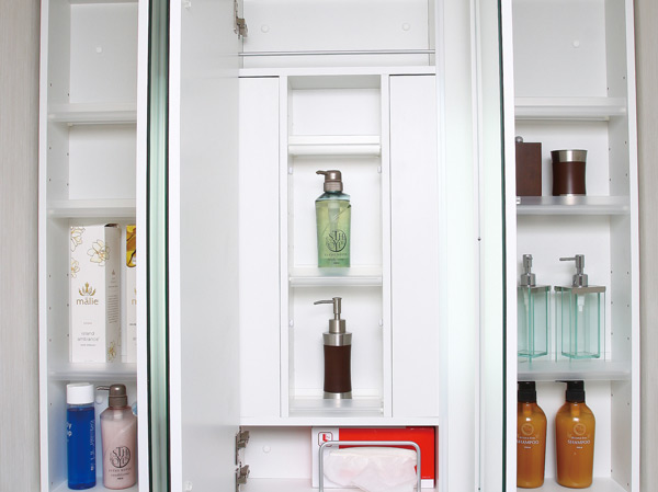 Bathing-wash room.  [Wide three-sided mirror that was nestled a cabinet with storage capacity on the back] Ensure sufficient storage space on the back side of the three-sided mirror. Keep refreshing around tend to wash basin mess.