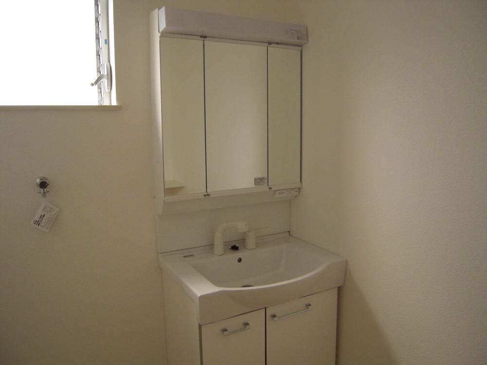 Wash basin, toilet. Bright washroom of there window