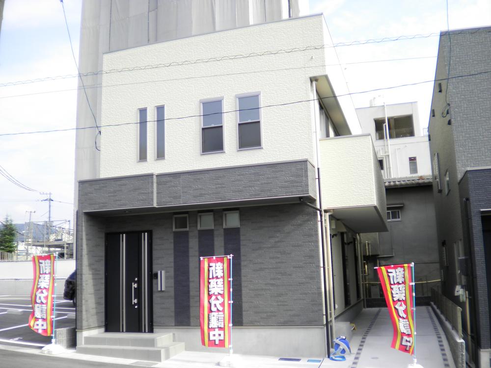 Local appearance photo. Bright white and chic gray of Building B. Bright house wrapped in plenty of sunlight