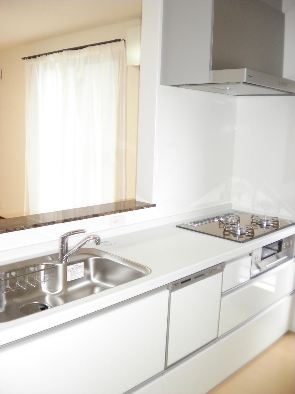 Kitchen. Built-in gas stove in the kitchen of the bright white-collar. Tableware clean shiny families with dish washing dryer. 