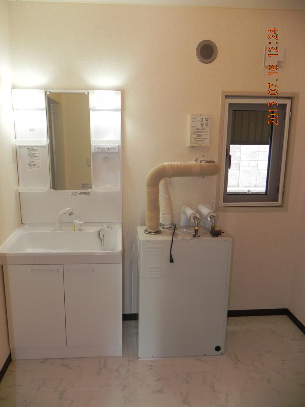 Wash basin, toilet. Hot water boiler is also new