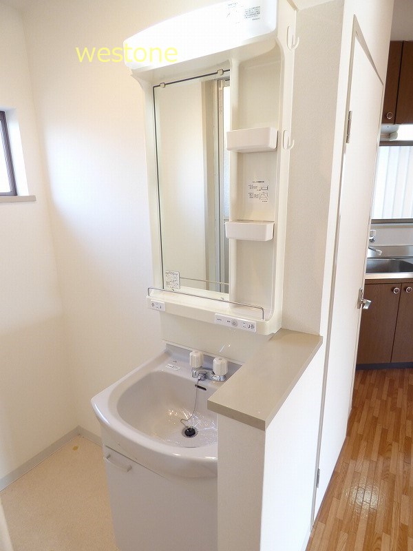 Washroom. Wash basin, Washing machine in the room. Window in washroom.