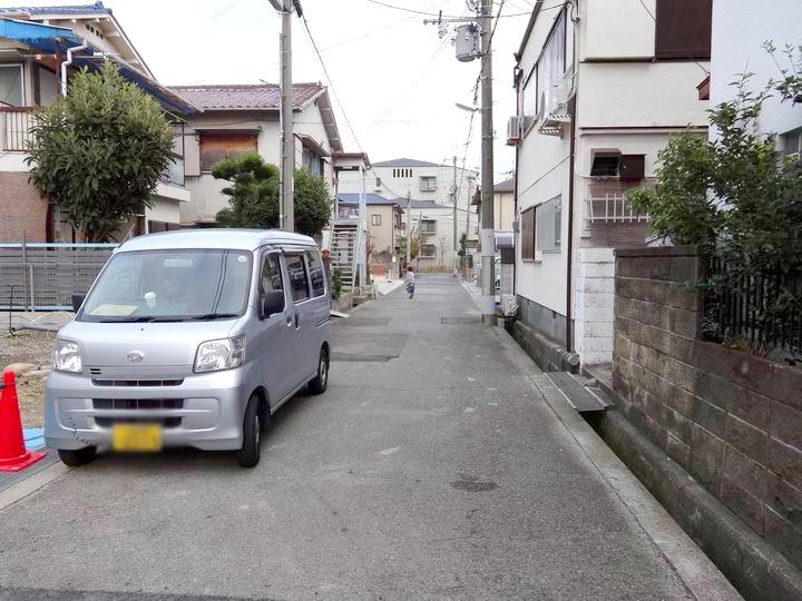 Local photos, including front road. Large passenger car is comfortably two available parking site