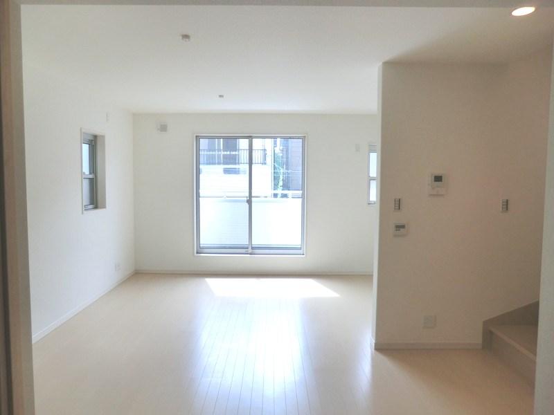 Living. Living room where the light is coming through the wide windows