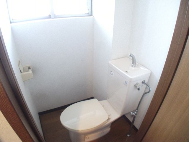 Toilet. It has a window in the toilet.