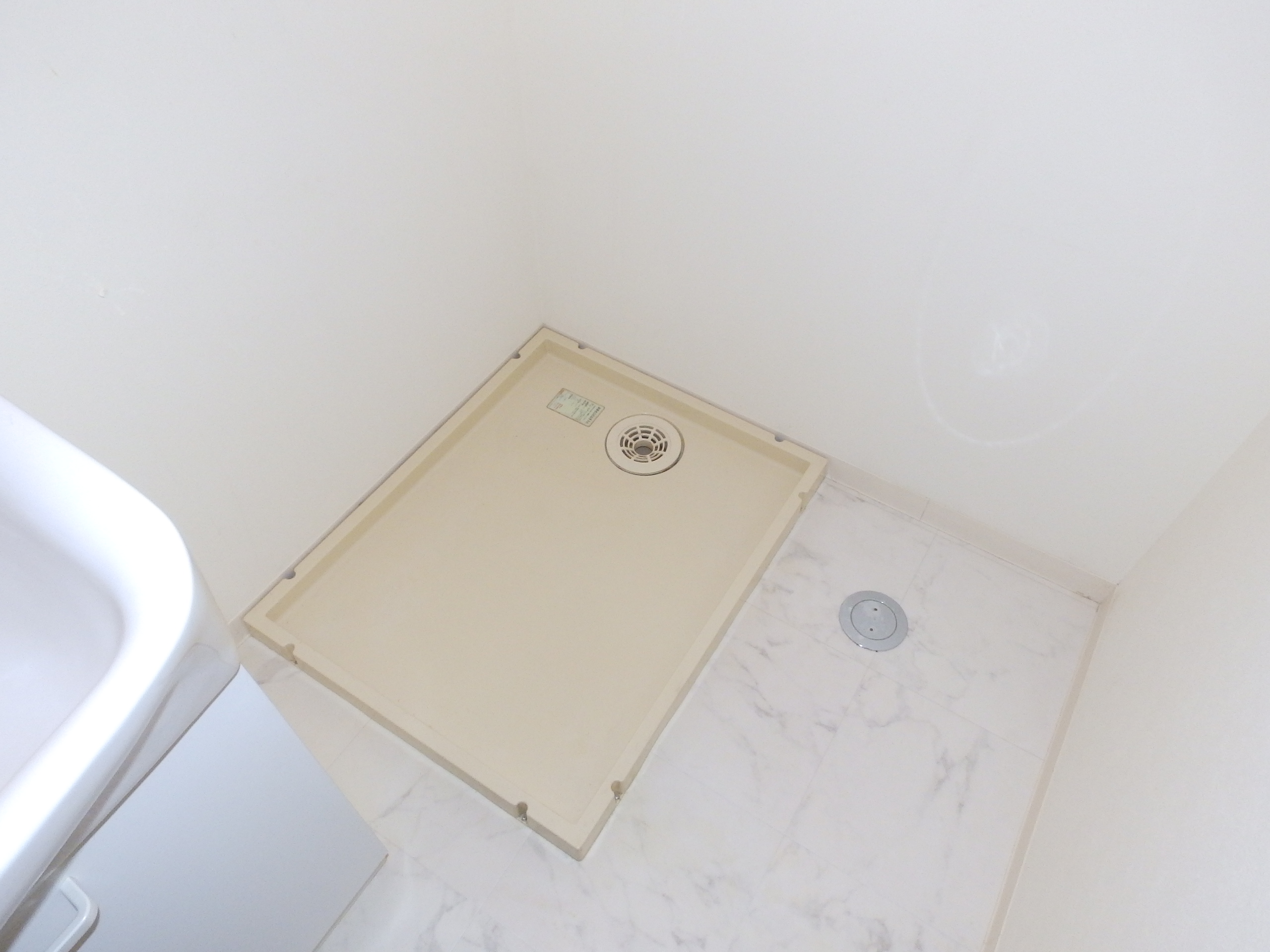 Washroom. Washing machine in the room