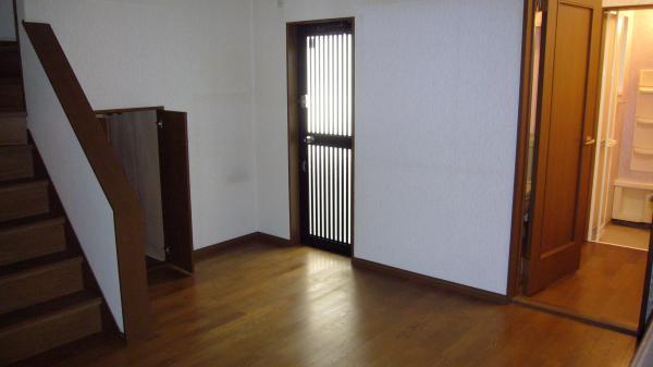 Living. The room is the kitchen door there is a kitchen Stairs under storage There